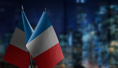 Small flags of the France on an abstract blurry background