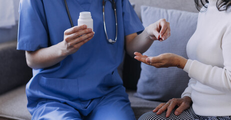 Homecare nursing service and elderly people cardiology healthcare. Close up of young hispanic female doctor nurse check mature caucasian man patient heartbeat using stethoscope during visit
