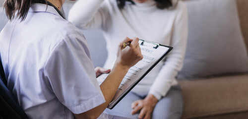 Homecare nursing service and elderly people cardiology healthcare. Close up of young hispanic female doctor nurse check mature caucasian man patient heartbeat using stethoscope during visit