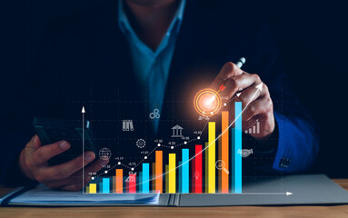 Business analysis, company profits. Businessman analyzing profit chart trends, making investment plans, trading stocks, economic trends, setting future goals. Analyze investment risks.