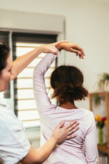 Teen Girl having chiropractic back adjustment. Osteopathy, Physiotherapy, Kinesiology. Bad posture...