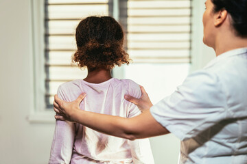 Teen Girl having chiropractic back adjustment. Osteopathy, Physiotherapy, Kinesiology. Bad posture...