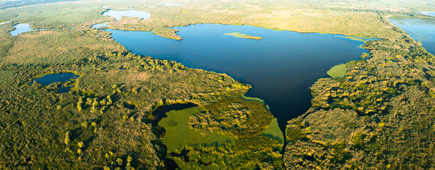 Danube Delta from above. Panoramic aerial view with the amazing Danube Delta landmark from Romania, nature landscapes with water and vegetation.