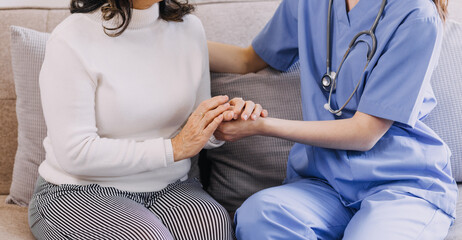 Homecare nursing service and elderly people cardiology healthcare. Close up of young hispanic female doctor nurse check mature caucasian man patient heartbeat using stethoscope during visit
