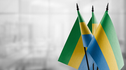 Small flags of the Gabon on an abstract blurry background