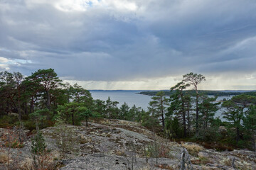 Fototapeta premium Shine and rain in nature reserve in the archipelago in Finland