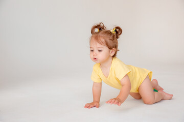 baby girl starting to walk crawling on a white background