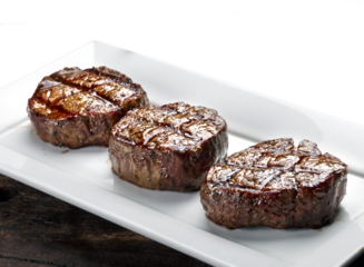 Three steaks roasted on the grill