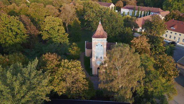 brandenburg Village church, golden hour sunset. Perfect aerial view flight drone
