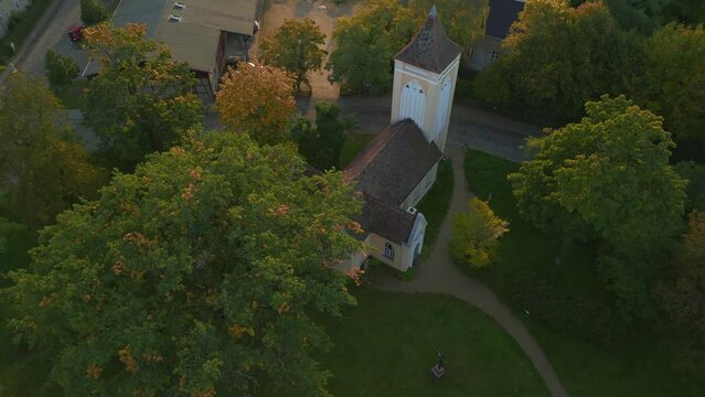 GDR Cross church with bell tower in the forest. Amazing aerial view flight drone