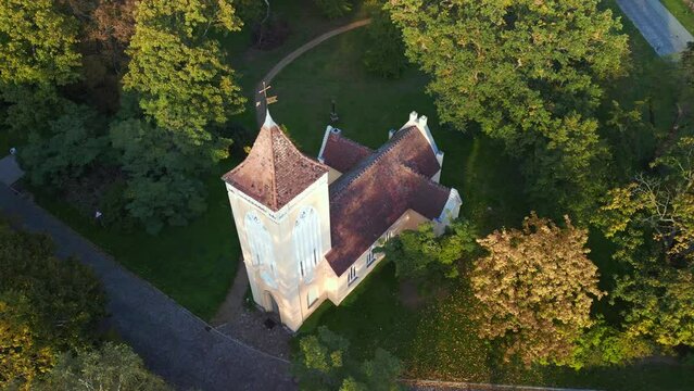 German Village church, summer evening car on road. Nice aerial view flight drone