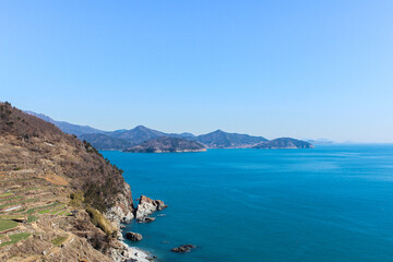 Fototapeta na wymiar Panoramic view of island and sea under blue sky.
