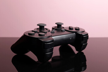 Wireless modern joystick gamepad on pink background, video game concept © Michael