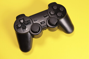 Wireless joystick gamepad controller on yellow background