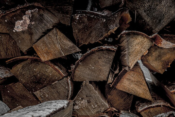 Heating the house in winter. A stack of wood. Firewood from chopped birch. Heat the stove. Chopping firewood. Warm house.