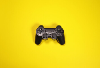 Wireless modern joystick gamepad on yellow background, minimalism style