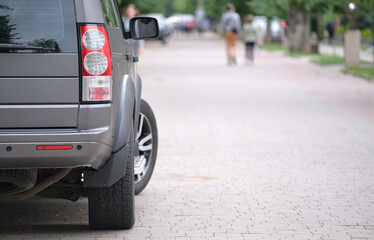 Close up of a car parked on city street side. Urban traffic concept