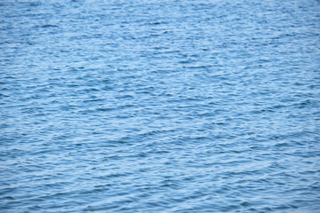 Closeup seascape surface of blue sea water with small ripple waves