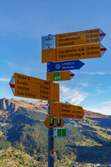 Signpost with directions to multiple destinations along the via alpina trail