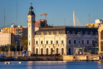 Landscape of the Port of Valencia with the clock tower at sunrise, Spain.