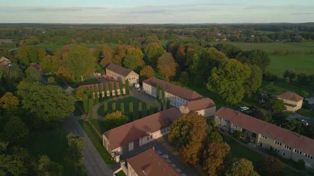 German Classicist castle in village of Paretz. Dramatic aerial view flight drone