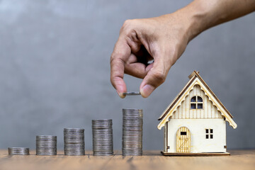 money coin stack grow up with small house, Saving money for buy home or resident concept.