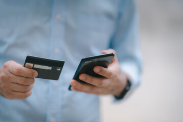 Man paying and shopping with smartphone application. Digital money transfer, banking and e commerce concept.Mobile payment with wallet app technology.