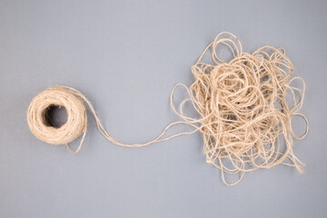 The tangled rope concept with a clew as the beginning of things, unravels the confused rope, and...