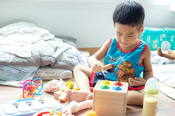 Happy kindergarten kids enjoying with wood toy together in cozy house