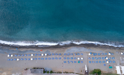 Drone aerial of beach umbrellas in the beach. Summer holidays in the sea. Paphos Cyprus Europe