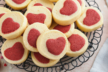 Valentines day cookies. Shortbread cookies inside a sweet red heart on pink plate on pink background. Mothers day. Womans day. Sweet holidays baking. Top view.