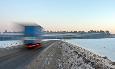A car was driving fast on the road