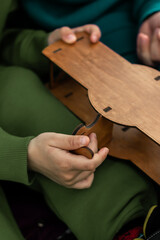 hands of the child playing with wooden blocks