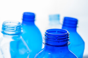 Plastic bottles, blue and transparent, crushed. Waste and plastic pollution, plastic recycling. 
