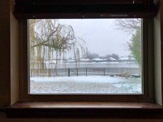 View of a winter scene framed by the windows
