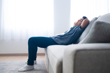 Full length of hispanic teenager boy relaxing and resting on couch