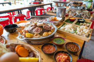 Wood Table with deliciouse seafood, shrimp, crab, mussle, pork saussage and vegetable in bbq grill restaurant from thailand