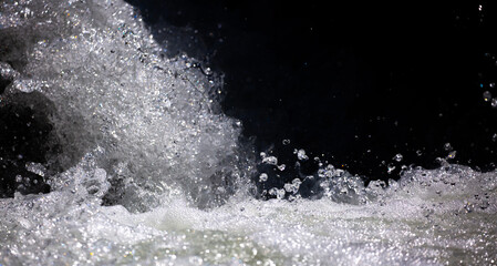 Drops of water, splashing and bubbling waterfall as a background. Foam party or laundry. The concept of freshness of soft drinks.