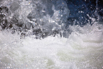 Drops of water, splashing and bubbling waterfall as a background. Foam party or laundry. The concept of freshness of soft drinks.