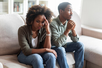 Frustrated african american couple feeling down after fight at home