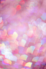 Defocused abstract bokeh background with pink pastel colored hearts, flare from lights, blurred bokeh holiday, celebration wallpaper. love and romance aesthetic photo, glittering lights pattern