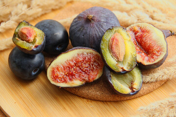 fresh figs and plum on a wooden table