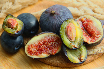 fresh figs and plum on a wooden table