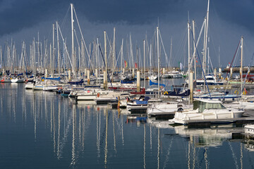 Boats with heavy reflection from masts in harbor of Cherbourg-Octoville, a commune in the peninsula of Cotentin in the Manche department in Lower Normandy in north-western France