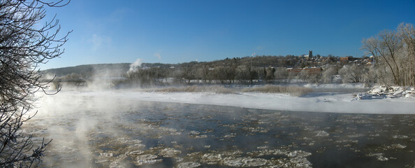 Sherbrooke Quebec Canada, winter landscape cold temperature frozen river mist and fog ice water panorama