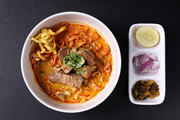 Khao Soi Thai Curry soup isolated in black background