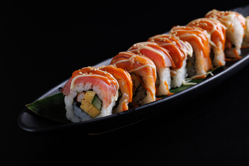Salmon Sushi roll Japanese food isolated in black background