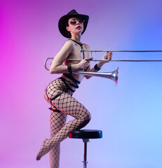 naked sexually attractive girl in a hat and stockings with brass musical instruments