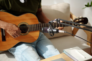 Musician set miscrophone to record sound of his acoustic guitar