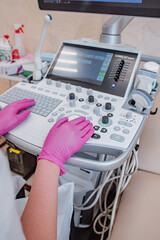 Probe for ultrasound diagnostics close-up. The doctor holds in his hands a transducer with a gel for ultrasound diagnostics of internal organs. Modern ultrasonic machine. Elastography and sonography.
